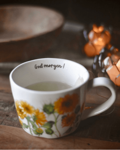 kopp med solsikkke og tekst god morgen